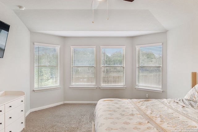 bedroom with light colored carpet and multiple windows