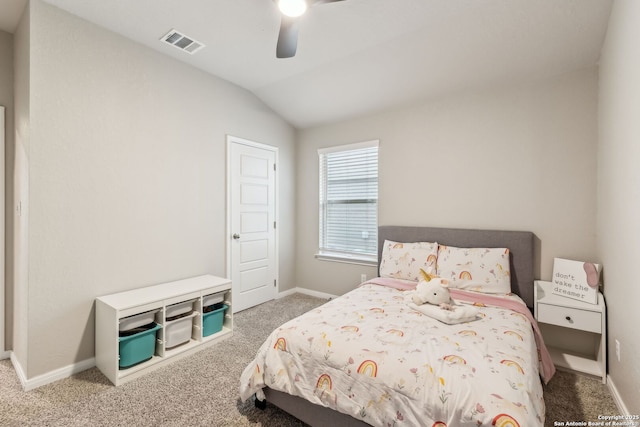 carpeted bedroom with ceiling fan and vaulted ceiling