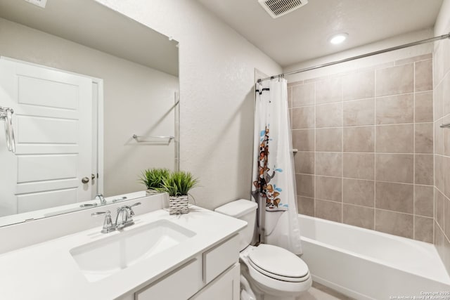 full bathroom featuring vanity, shower / tub combo, and toilet