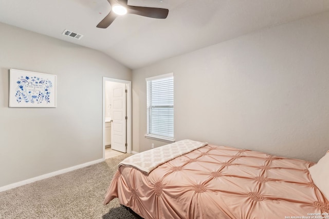 bedroom featuring vaulted ceiling, light carpet, ceiling fan, and ensuite bath