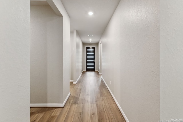 corridor featuring wood-type flooring