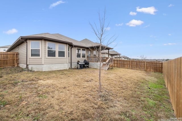 rear view of property featuring a yard