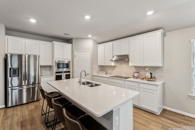 kitchen featuring stainless steel appliances, white cabinetry, and sink