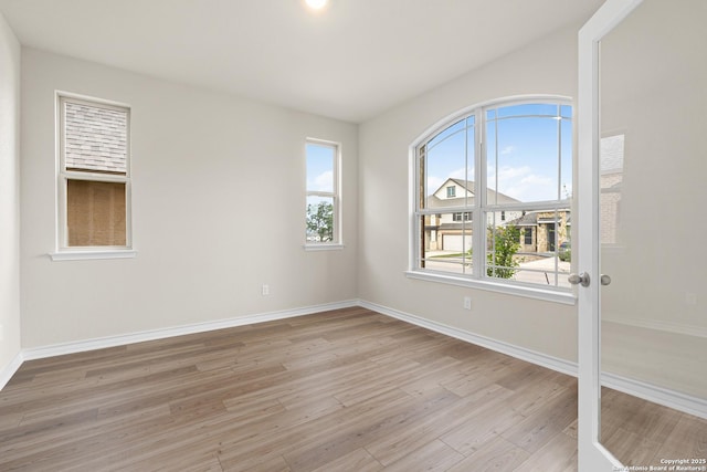 empty room featuring light hardwood / wood-style floors and a healthy amount of sunlight