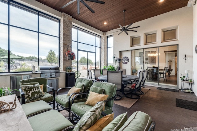 sunroom featuring wooden ceiling and ceiling fan