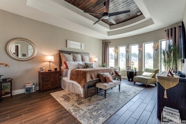 bedroom with a raised ceiling and ceiling fan