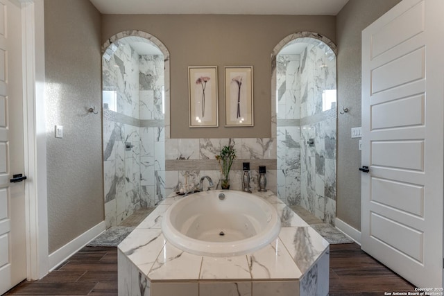 bathroom with hardwood / wood-style flooring and independent shower and bath