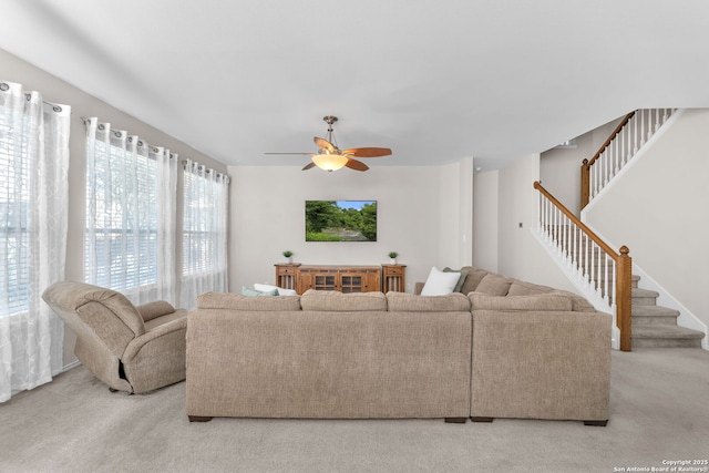 carpeted living room with ceiling fan