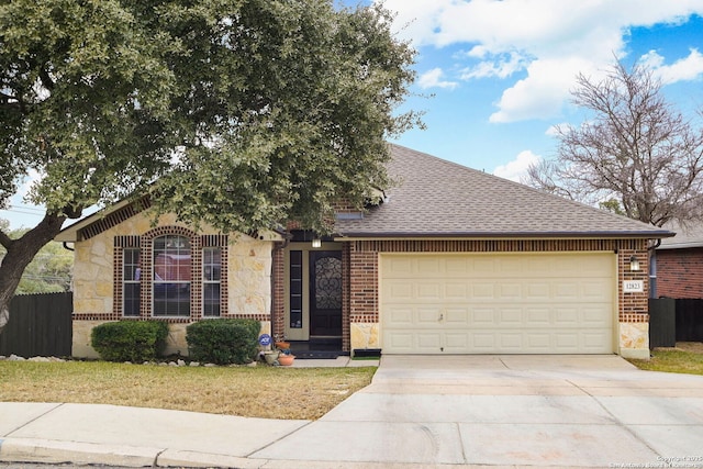 ranch-style house with stone siding, roof with shingles, concrete driveway, and brick siding