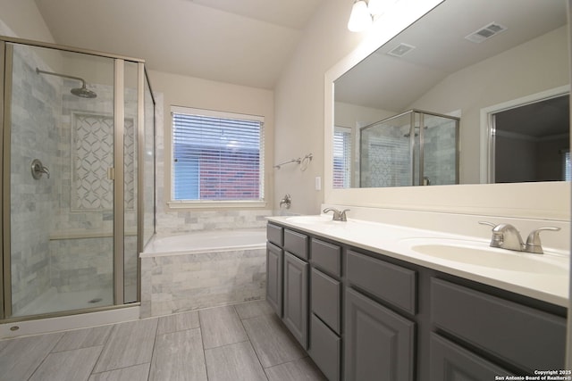 bathroom with lofted ceiling, separate shower and tub, and vanity