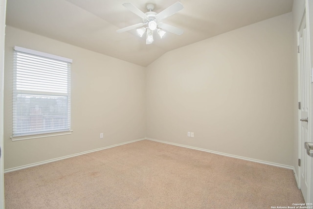 carpeted spare room with ceiling fan and lofted ceiling