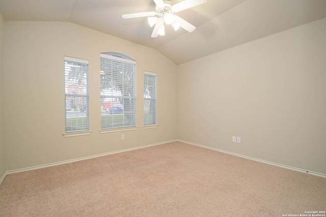 carpeted spare room with lofted ceiling and ceiling fan