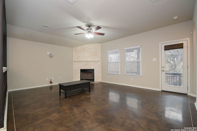 living room with ceiling fan and a fireplace