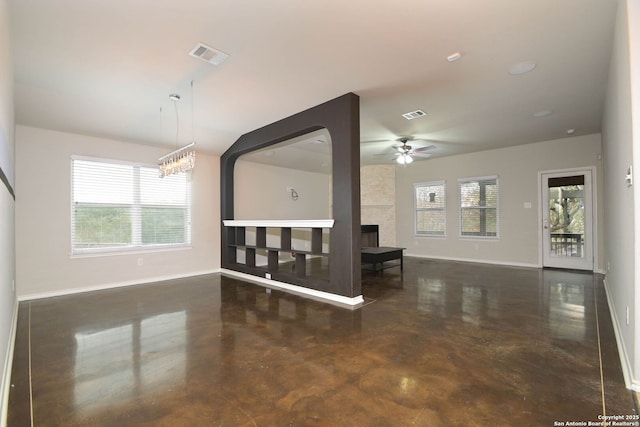 unfurnished living room featuring a large fireplace and ceiling fan