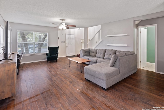 living room with ceiling fan, hardwood / wood-style floors, and a textured ceiling