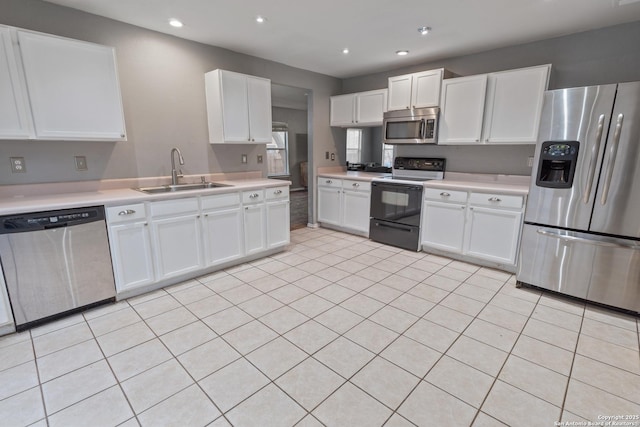 kitchen with white cabinetry, sink, and stainless steel appliances