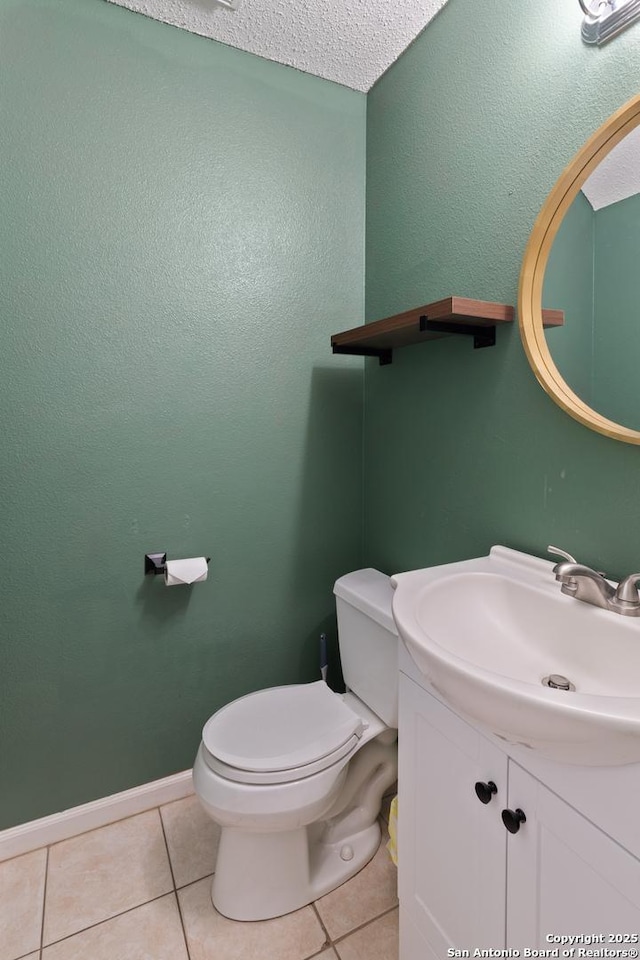 bathroom featuring tile patterned flooring, vanity, and toilet