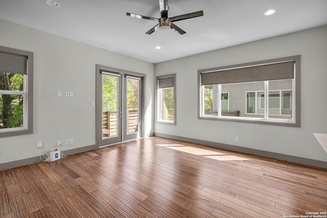 unfurnished room with ceiling fan and light wood-type flooring