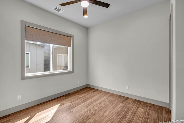 empty room with light hardwood / wood-style flooring and ceiling fan