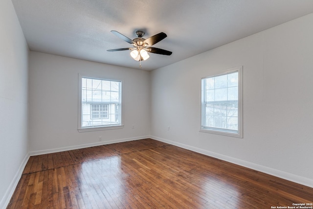 empty room featuring dark hardwood / wood-style floors and ceiling fan