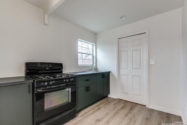 kitchen with sink, light hardwood / wood-style floors, and gas stove