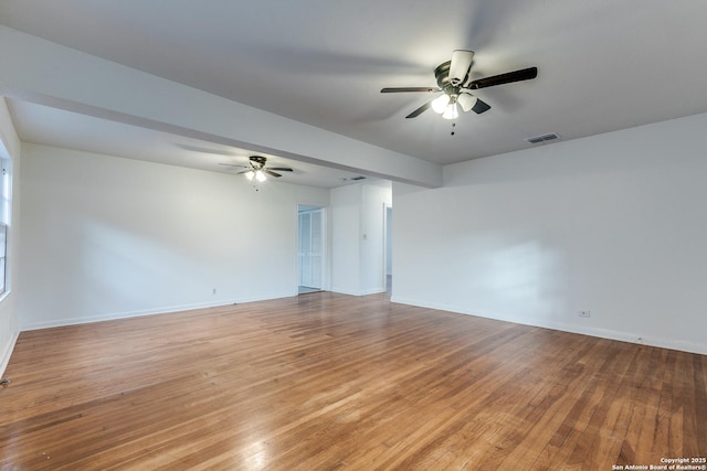 empty room with ceiling fan and light hardwood / wood-style flooring