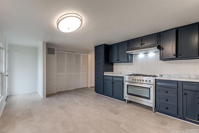 kitchen with light stone countertops and stainless steel range