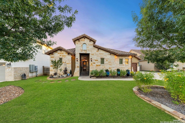 mediterranean / spanish house featuring a lawn