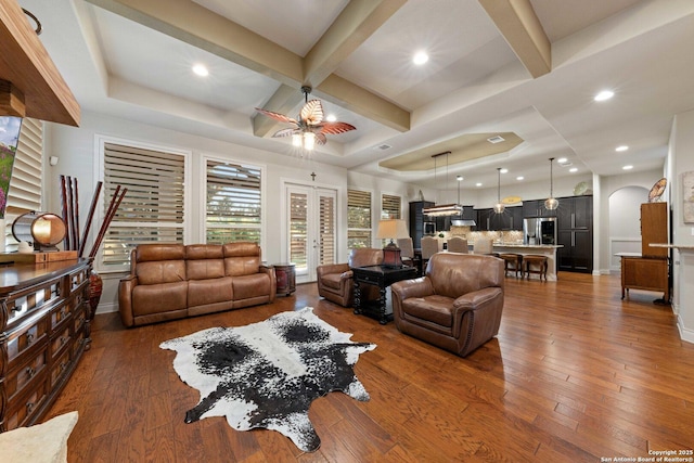 living room featuring coffered ceiling, beam ceiling, and dark hardwood / wood-style floors