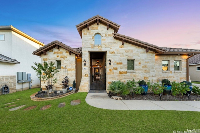 mediterranean / spanish home featuring a yard