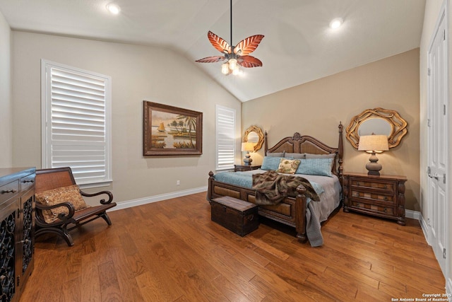 bedroom featuring hardwood / wood-style flooring, vaulted ceiling, and ceiling fan