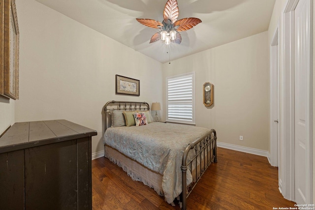 bedroom with dark hardwood / wood-style floors and ceiling fan