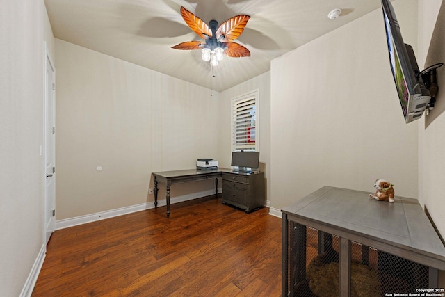 home office with ceiling fan and dark hardwood / wood-style floors