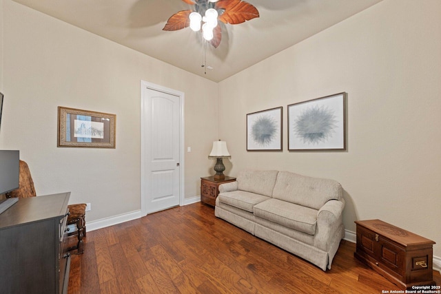 living room featuring dark hardwood / wood-style floors and ceiling fan