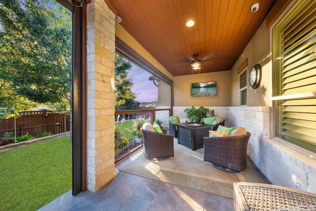 patio terrace at dusk featuring outdoor lounge area and ceiling fan