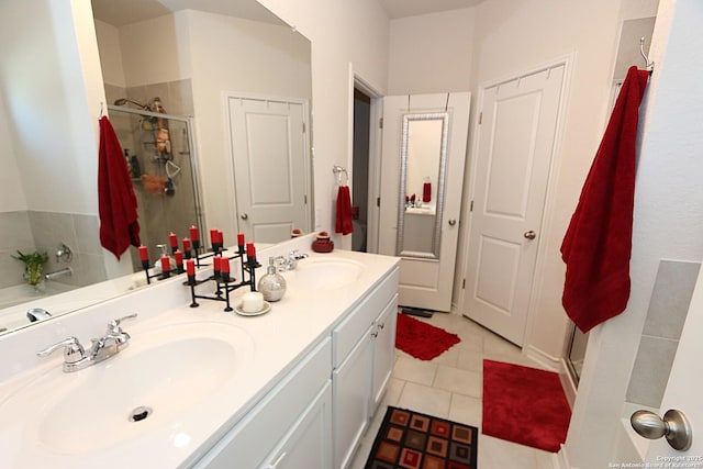 bathroom with tile patterned flooring, vanity, and a shower with door