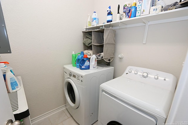 washroom featuring light tile patterned floors and washer and clothes dryer