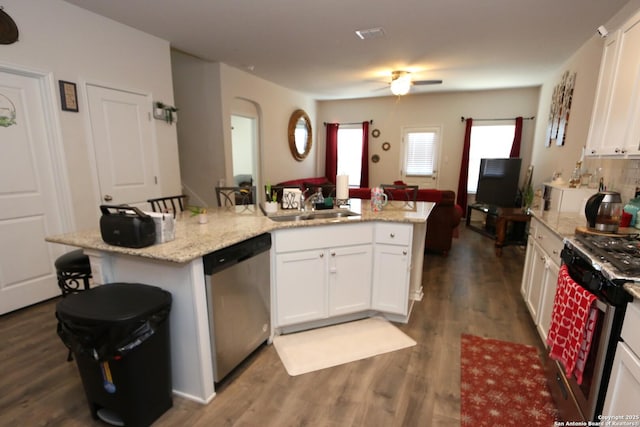 kitchen with appliances with stainless steel finishes, a kitchen breakfast bar, a kitchen island, and white cabinets