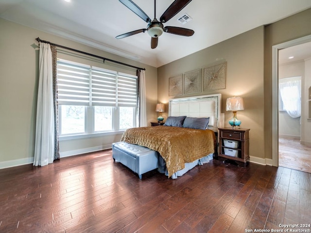 bedroom with dark hardwood / wood-style flooring and ceiling fan