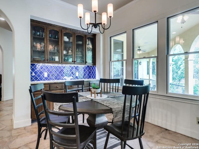 dining area with an inviting chandelier and crown molding