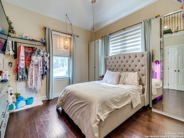 bedroom with dark hardwood / wood-style flooring