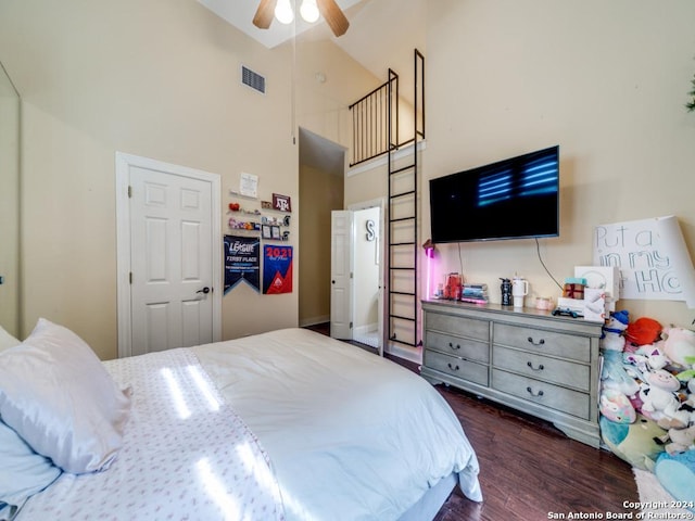 bedroom featuring ceiling fan, dark hardwood / wood-style floors, and high vaulted ceiling