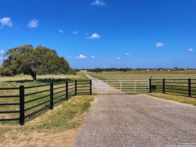 view of gate with a rural view