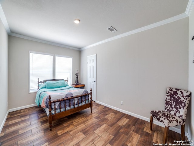 bedroom featuring crown molding and dark hardwood / wood-style flooring