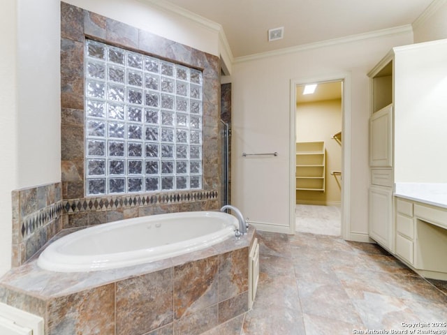 bathroom with crown molding, tiled bath, and vanity