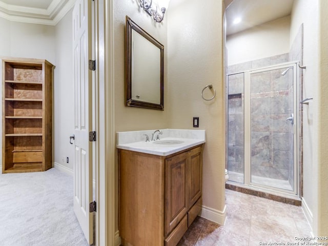 bathroom with crown molding, vanity, and an enclosed shower