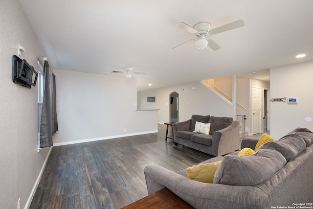 living room with dark hardwood / wood-style floors and ceiling fan