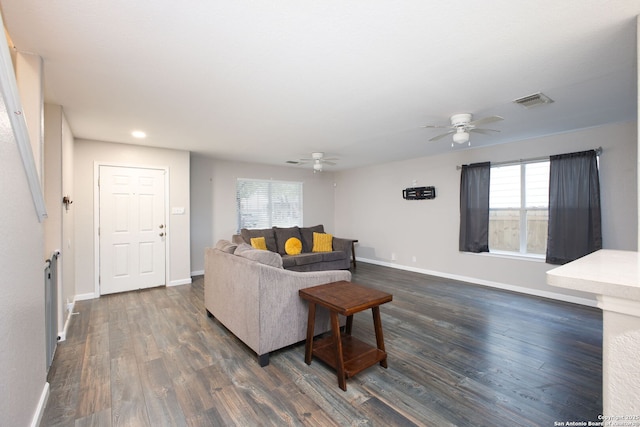 living room with dark wood-type flooring and ceiling fan