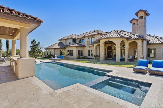 view of swimming pool featuring an in ground hot tub and a patio area