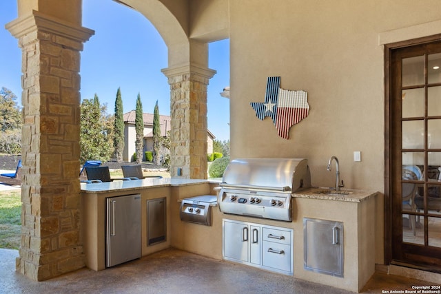 view of patio / terrace with an outdoor kitchen, grilling area, and sink